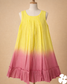 Yellow to pink gradient dress on a mannequin against a beige background